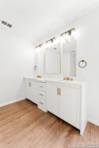 a bathroom with a double vanity sink mirror and vanity