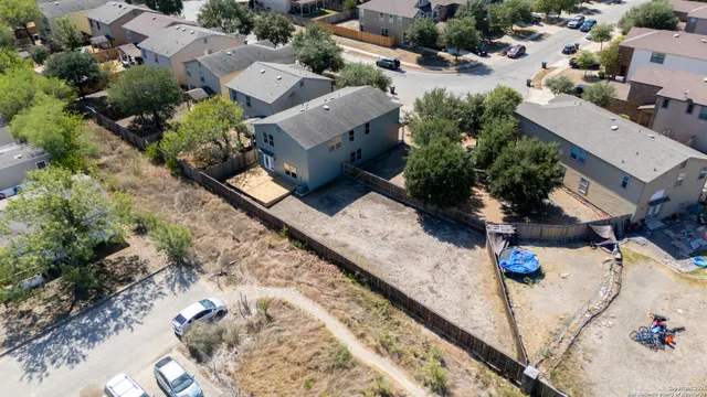 an aerial view of a house with a yard