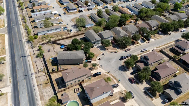 an aerial view of multiple houses with yard