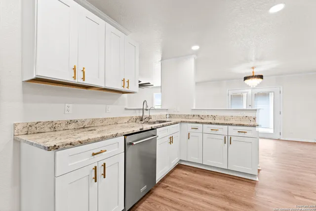 a kitchen with a sink stove and cabinets
