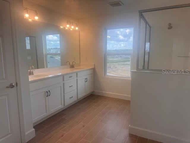4411 Laurel Site Loop Apopka, FL 32712 - Photo 11 of 14 a view of a kitchen with white cabinets and wooden floor