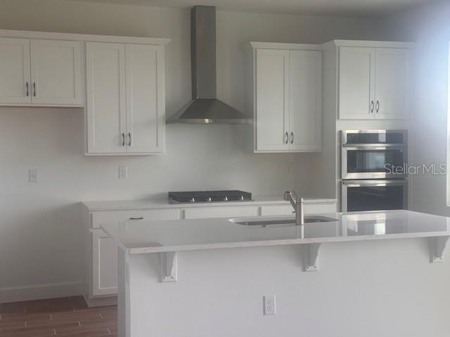 4411 Laurel Site Loop Apopka, FL 32712 - Photo 3 of 14 a kitchen with stainless steel appliances white cabinets and a sink