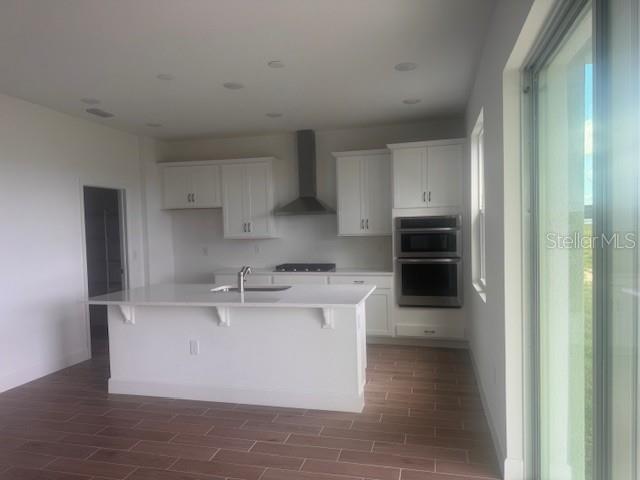 4411 Laurel Site Loop Apopka, FL 32712 - Photo 4 of 14 a kitchen with kitchen island stainless steel appliances a sink stove and refrigerator