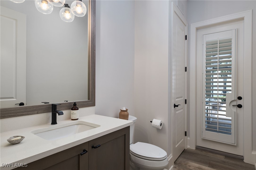 43466 Waterside Trail Punta Gorda, FL 33982 - Photo 11 of 32 a bathroom with a granite countertop sink toilet a mirror a vanity and shower