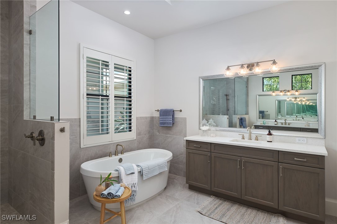 43466 Waterside Trail Punta Gorda, FL 33982 - Photo 18 of 32 a spacious bathroom with a sink mirror and a bathtub