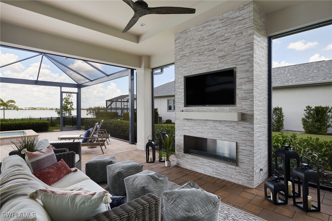 43466 Waterside Trail Punta Gorda, FL 33982 - Photo 19 of 32 a living room with furniture a fireplace and a flat screen tv