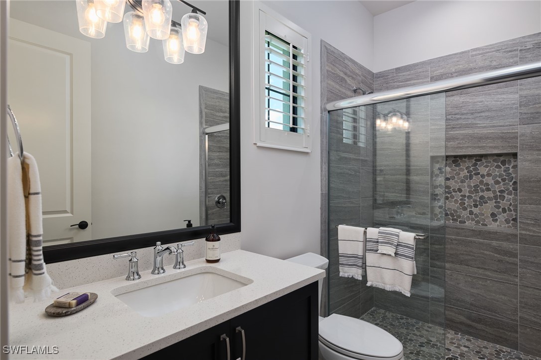 43466 Waterside Trail Punta Gorda, FL 33982 - Photo 21 of 32 a bathroom with a sink a toilet and shower