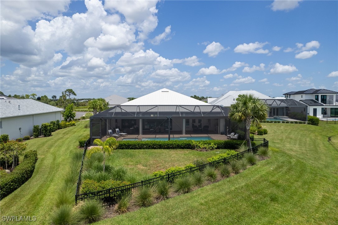 43466 Waterside Trail Punta Gorda, FL 33982 - Photo 28 of 32 a backyard of a house with table and chairs plants and large tree