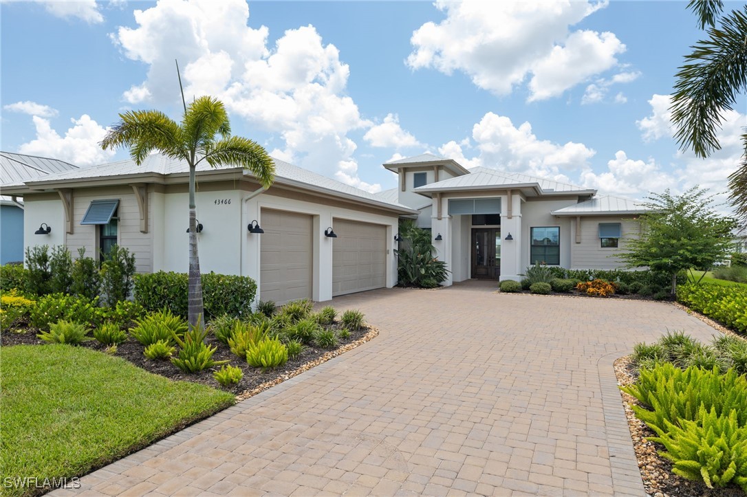 43466 Waterside Trail Punta Gorda, FL 33982 - Photo 3 of 32 a front view of a house with a garden