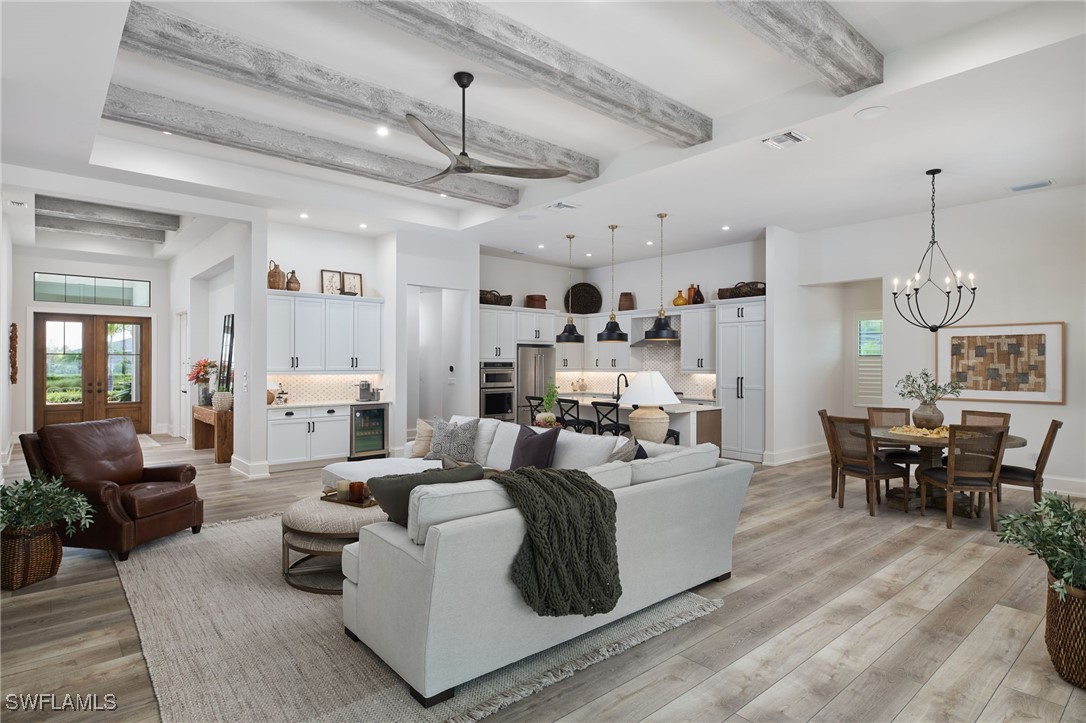 43466 Waterside Trail Punta Gorda, FL 33982 - Photo 6 of 32 a living room with lots of furniture and a chandelier