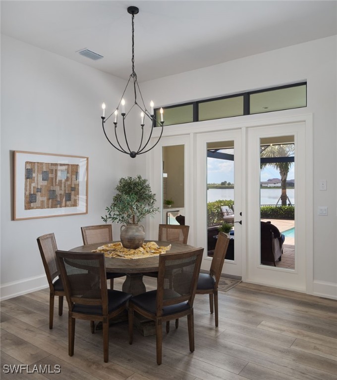 43466 Waterside Trail Punta Gorda, FL 33982 - Photo 8 of 32 a dining room with furniture a chandelier and wooden floor