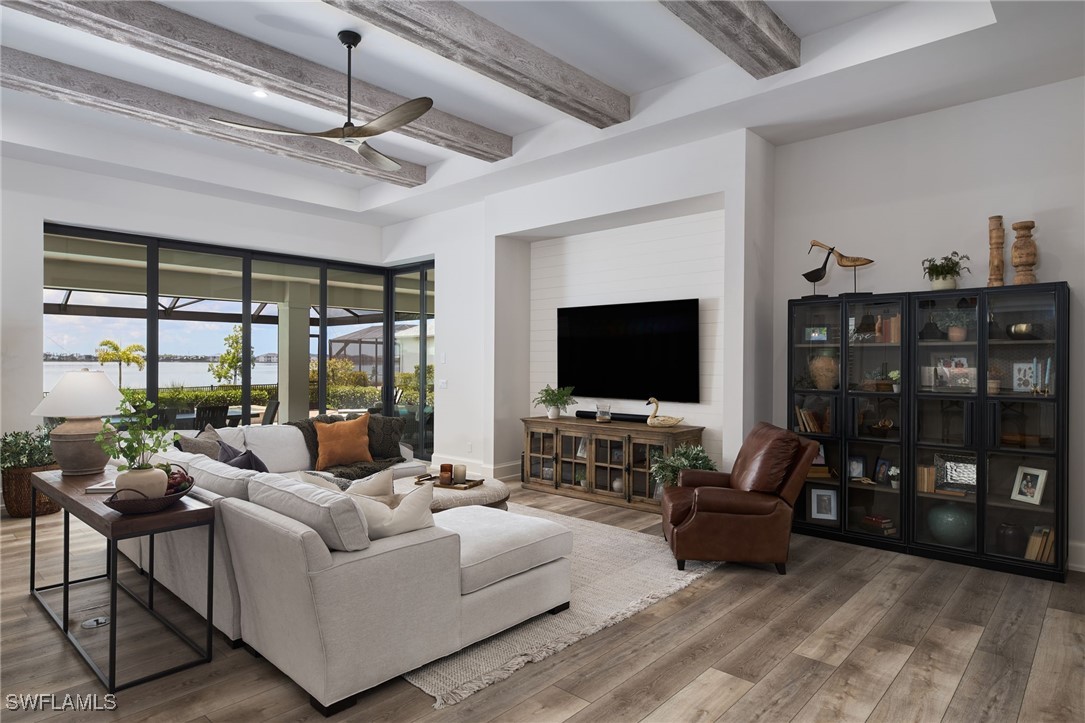 43466 Waterside Trail Punta Gorda, FL 33982 - Photo 9 of 32 a living room with furniture a flat screen tv and a fireplace