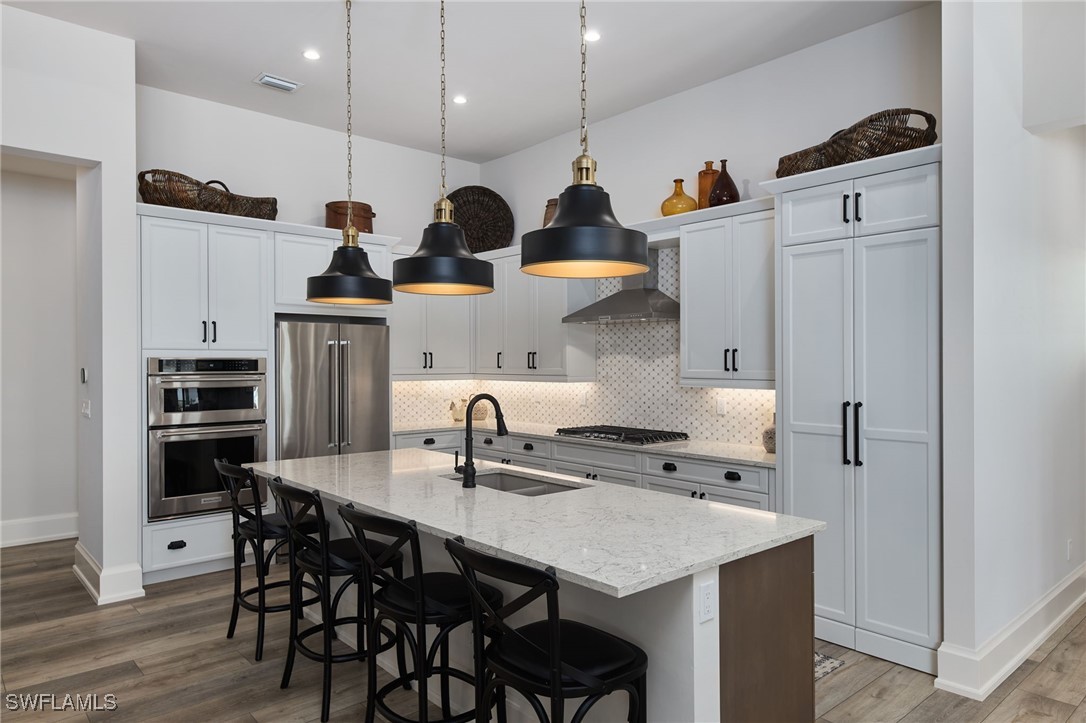43466 Waterside Trail Punta Gorda, FL 33982 - Photo 10 of 32 a kitchen with stainless steel appliances kitchen island granite countertop a kitchen island a stove a table and chairs