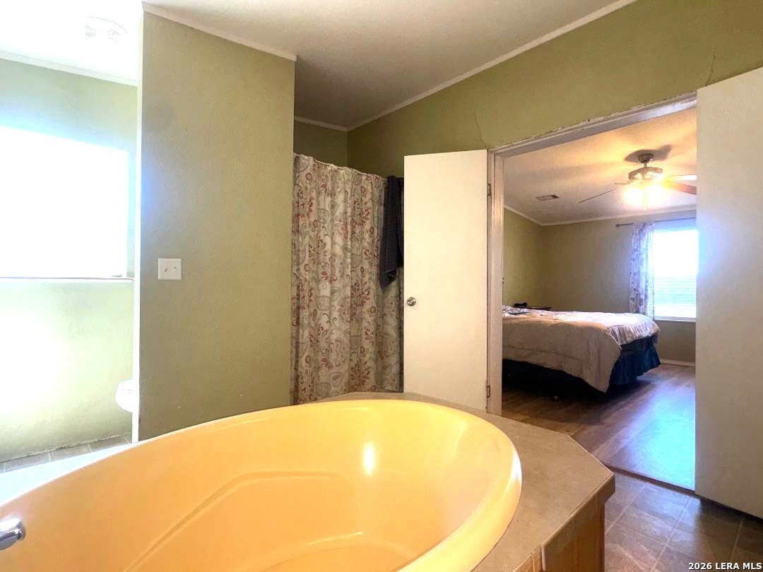 435 N Trail Pleasanton, TX 78064 - Photo 11 of 19 a bedroom with a bed and a couch