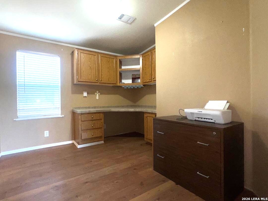 435 N Trail Pleasanton, TX 78064 - Photo 12 of 19 a room with a chair and a ceiling fan