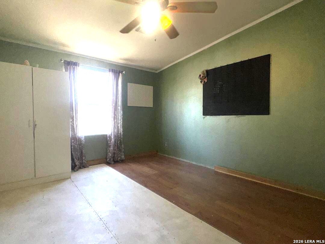 435 N Trail Pleasanton, TX 78064 - Photo 14 of 19 a view of a livingroom with a chandelier fan and a window