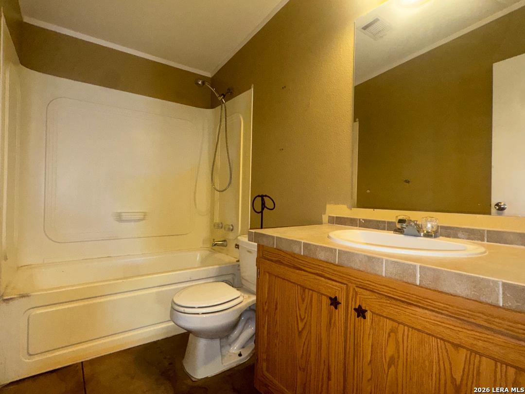 435 N Trail Pleasanton, TX 78064 - Photo 15 of 19 a bathroom with a granite countertop sink toilet and shower