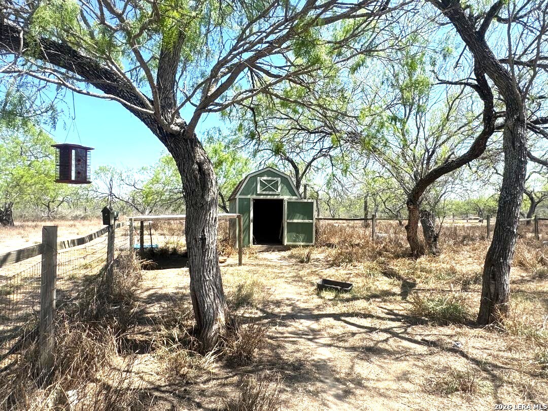 435 N Trail Pleasanton, TX 78064 - Photo 3 of 19 a view of a yard covered in snow