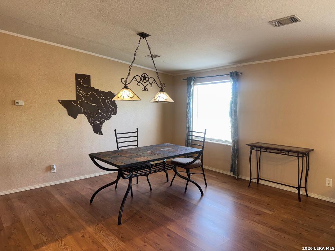 435 N Trail Pleasanton, TX 78064 - Photo 5 of 19 a view of a workspace with furniture window and wooden floor