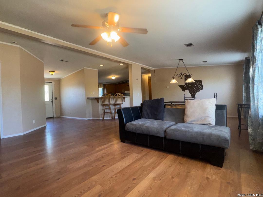 435 N Trail Pleasanton, TX 78064 - Photo 6 of 19 a living room with furniture and a chandelier
