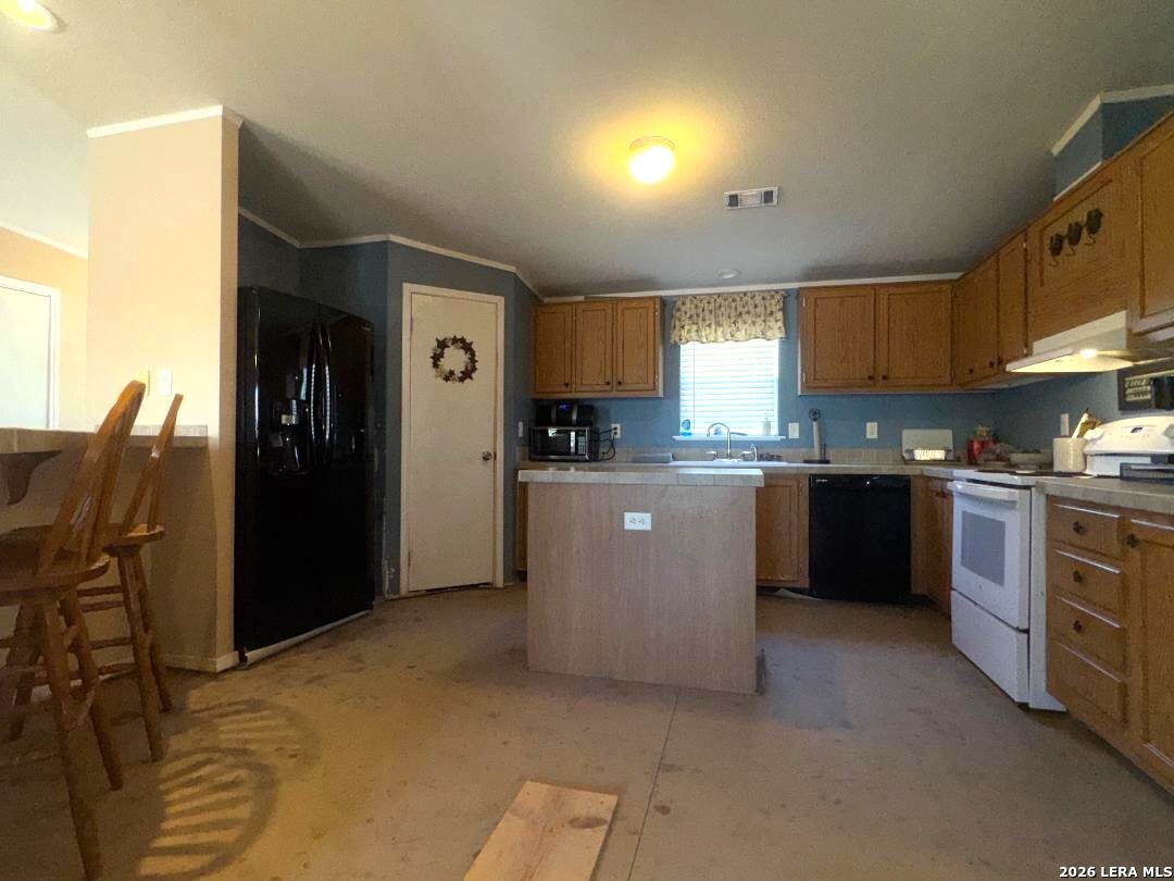 435 N Trail Pleasanton, TX 78064 - Photo 7 of 19 a kitchen with stainless steel appliances granite countertop a refrigerator and a stove top oven