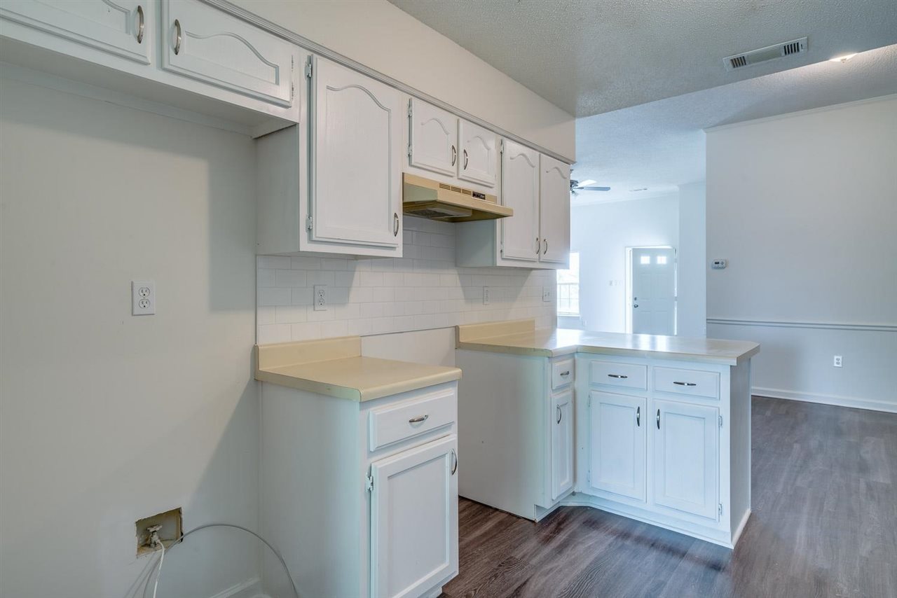 4233 Meadow Ridge Trail Memphis, TN 38141 - Photo 11 of 21 a kitchen with cabinets stainless steel appliances and wooden floor