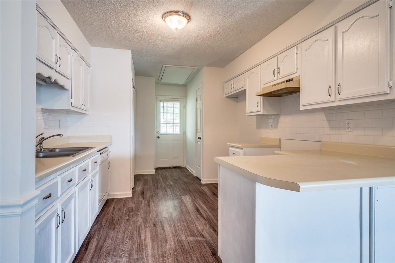 4233 Meadow Ridge Trail Memphis, TN 38141 - Photo 12 of 21 a kitchen with granite countertop a sink stove and cabinets
