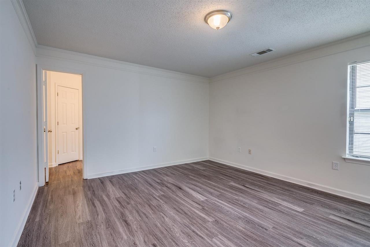 4233 Meadow Ridge Trail Memphis, TN 38141 - Photo 13 of 21 an empty room with wooden floor and windows