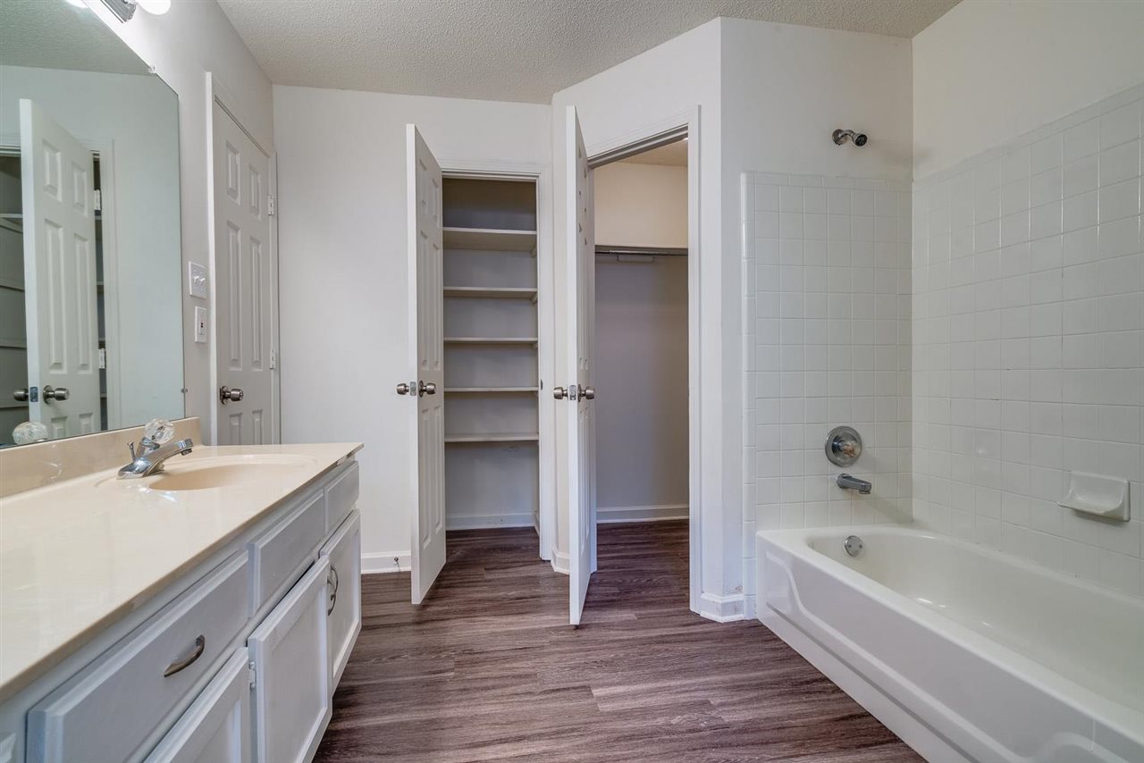 4233 Meadow Ridge Trail Memphis, TN 38141 - Photo 16 of 21 a bathroom with a tub sink and mirror