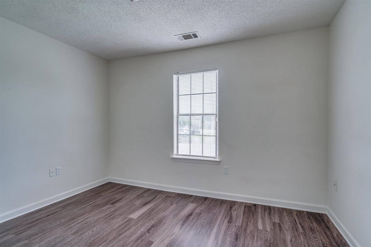 4233 Meadow Ridge Trail Memphis, TN 38141 - Photo 17 of 21 an empty room with wooden floor and windows