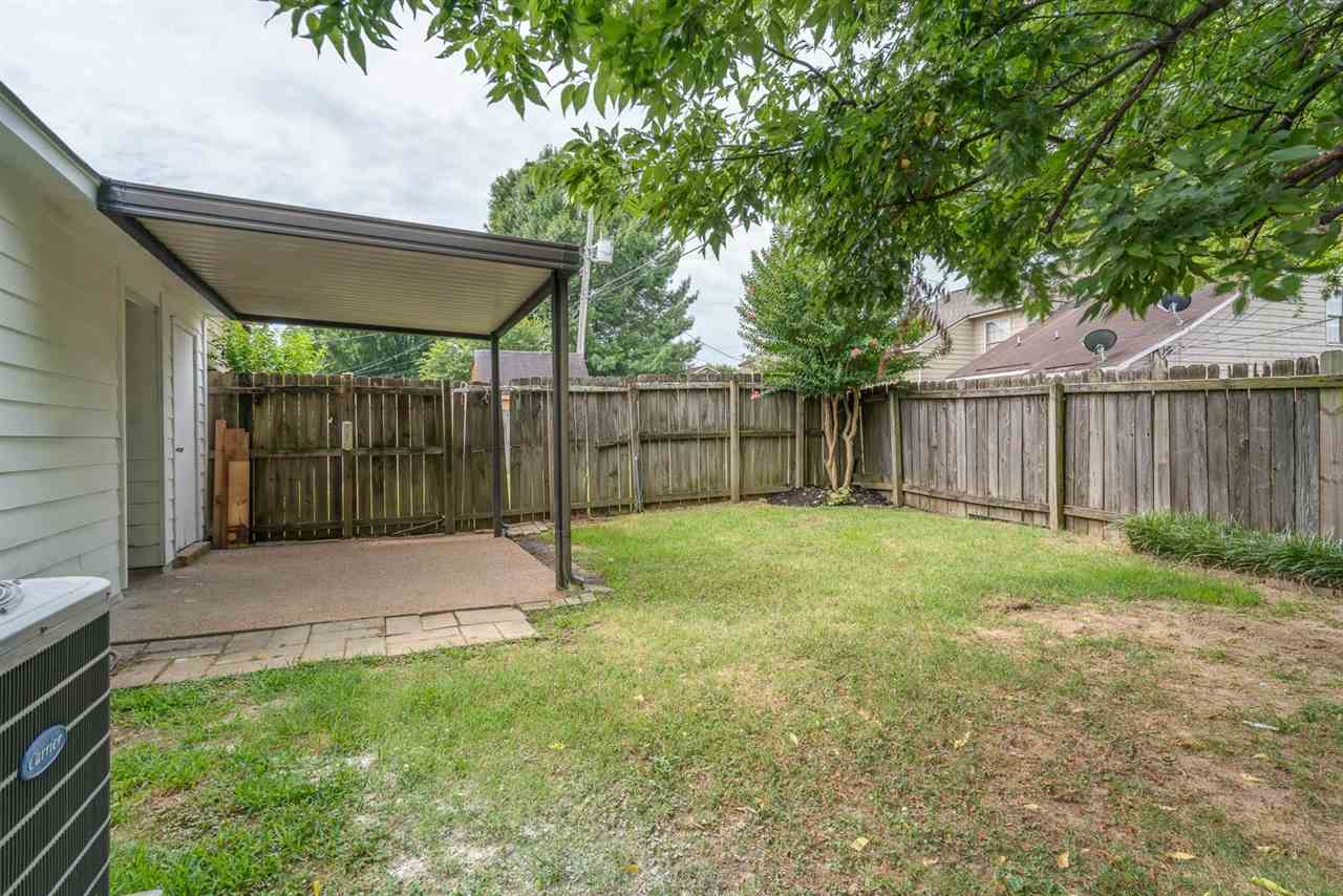 4233 Meadow Ridge Trail Memphis, TN 38141 - Photo 20 of 21 a view of a backyard with a small cabin and a chair