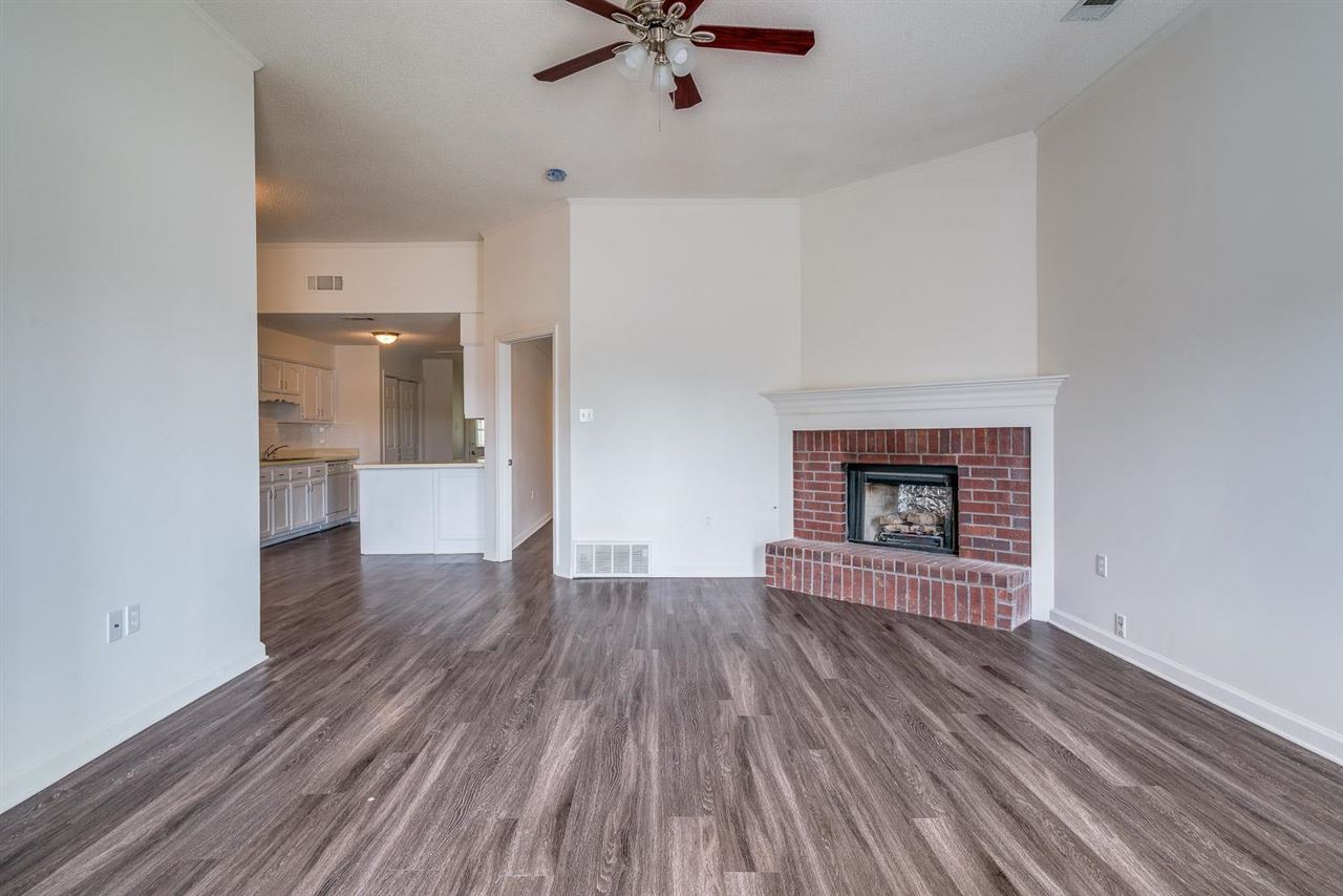 4233 Meadow Ridge Trail Memphis, TN 38141 - Photo 5 of 21 wooden floor in an empty room with a fireplace
