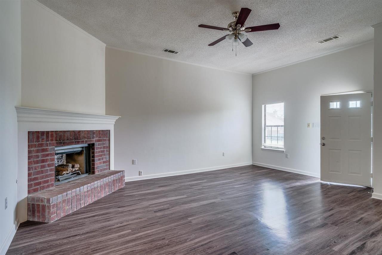 4233 Meadow Ridge Trail Memphis, TN 38141 - Photo 6 of 21 a view of a livingroom with a fireplace a ceiling fan and a fireplace