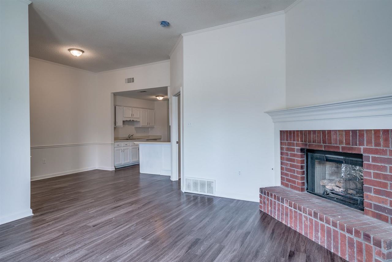 4233 Meadow Ridge Trail Memphis, TN 38141 - Photo 8 of 21 a living room with wooden floors and a fireplace