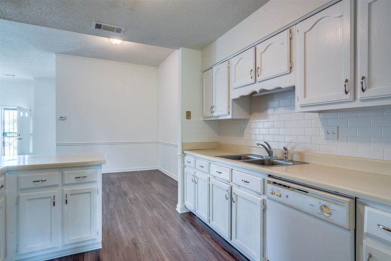 4233 Meadow Ridge Trail Memphis, TN 38141 - Photo 10 of 21 a kitchen with white cabinets and sink