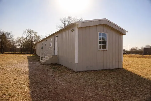 a view of a house with backyard and lake view