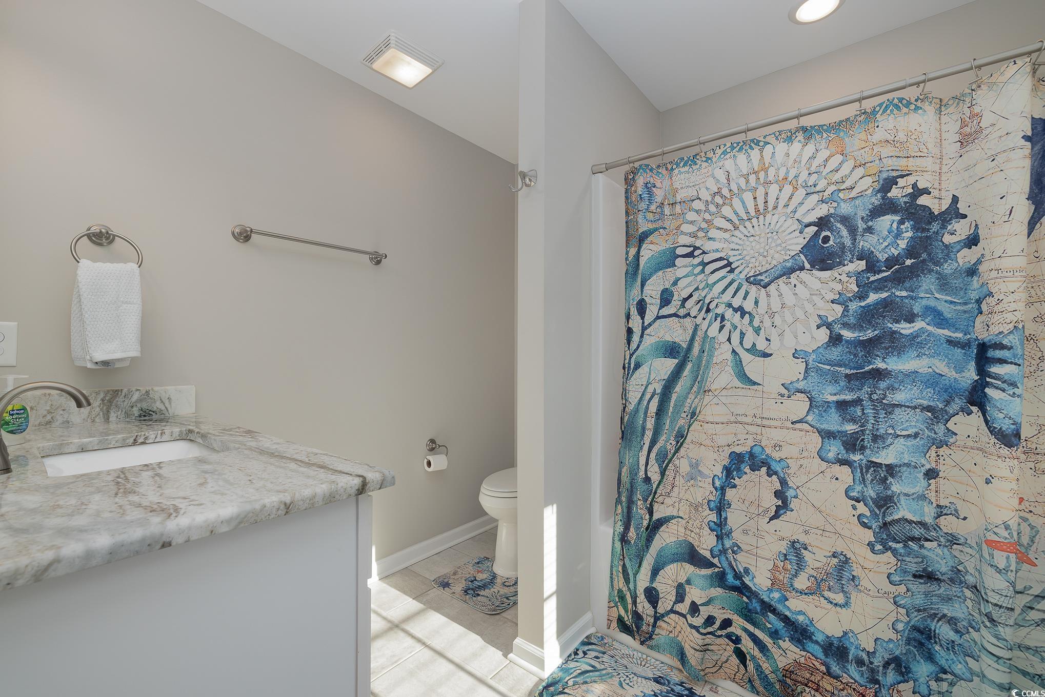 618 Surfside Drive Surfside Beach, SC 29575 - Photo 25 of 40 Bathroom featuring vanity, toilet, and tile patter