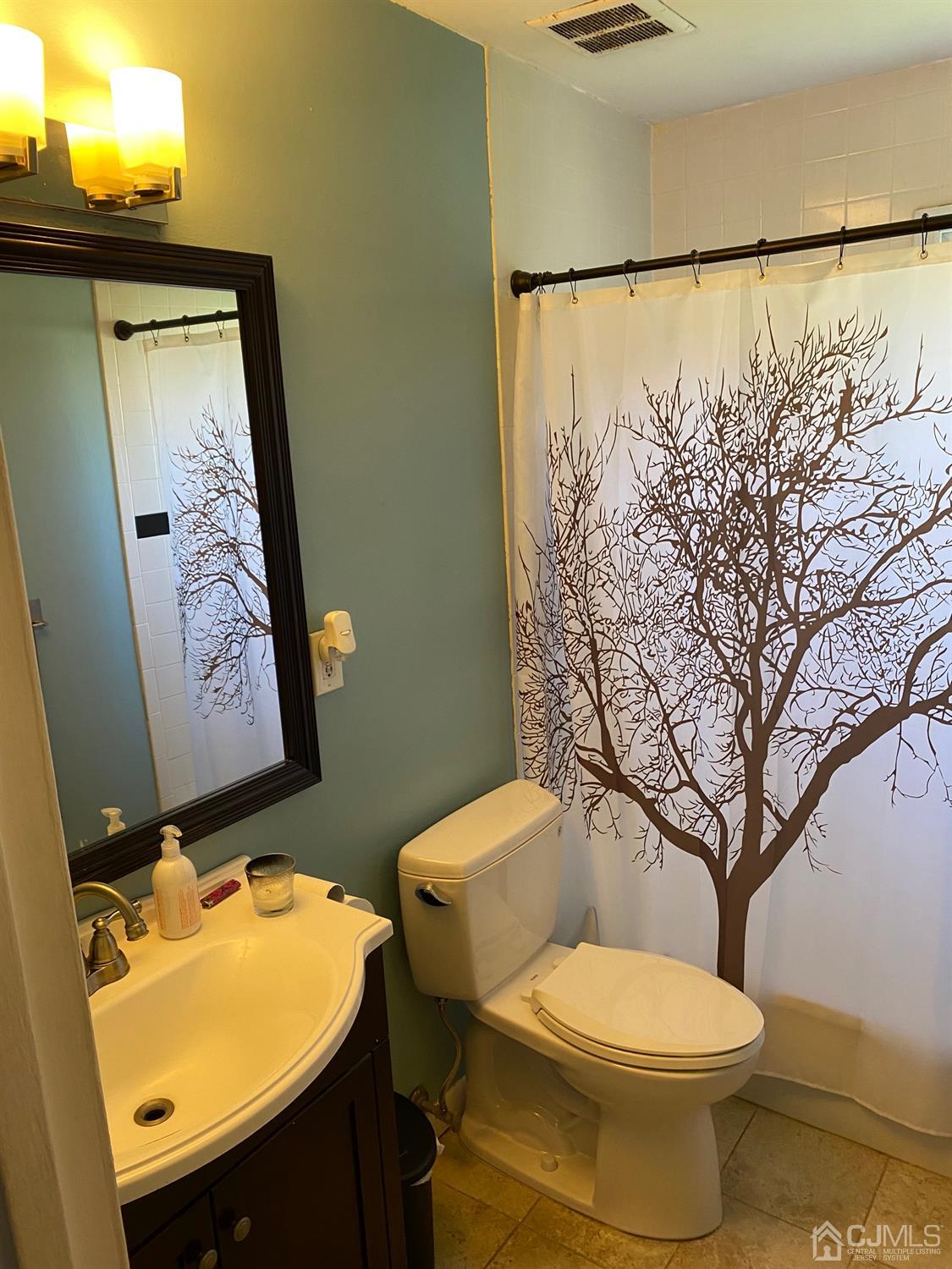 7 Colton Road Edison, NJ 08817 - Photo 8 of 9 a bathroom with a toilet sink and mirror