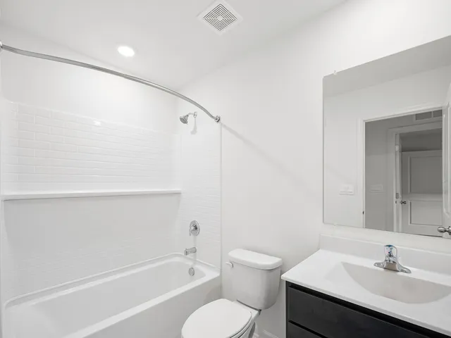 a bathroom with a sink toilet a vanity and shower