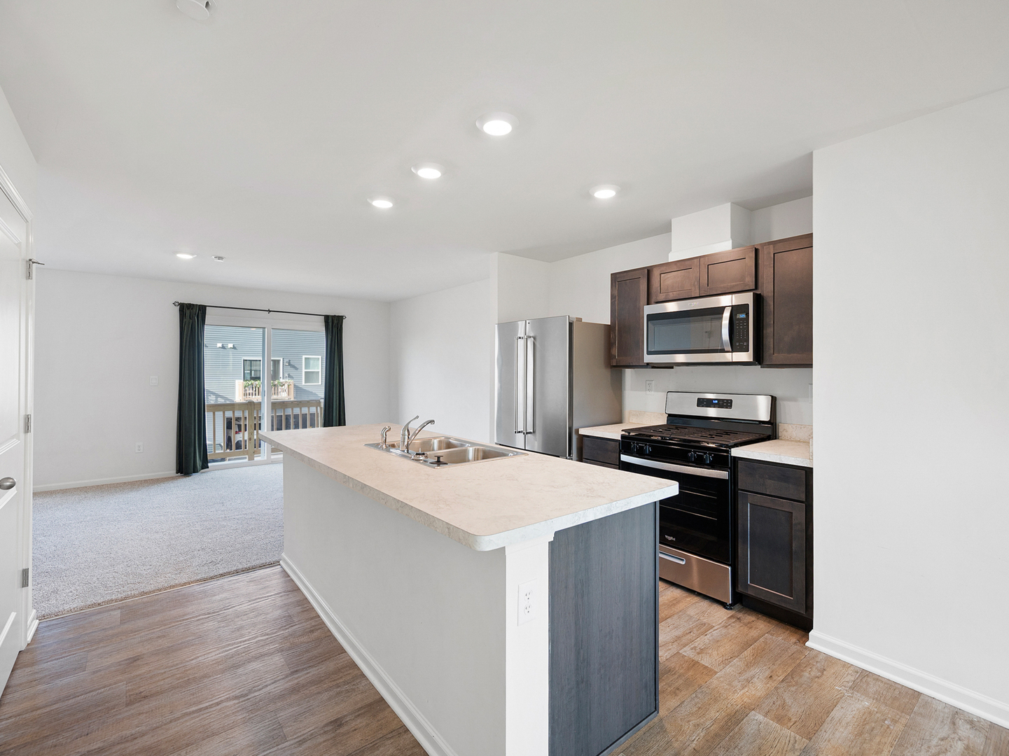 1533 Yosemite Way Pingree Grove, IL 60140 - Photo 2 of 17 a large kitchen with kitchen island a sink dishwasher stove and refrigerator with wooden floor