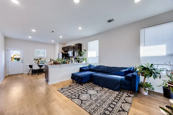 a living room with furniture and wooden floor