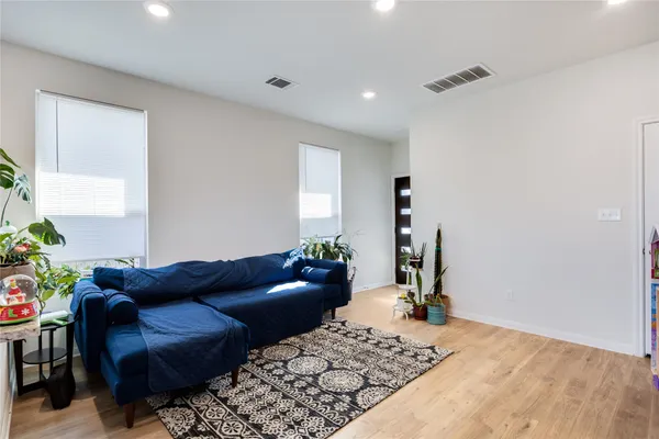 a living room with furniture and a potted plant