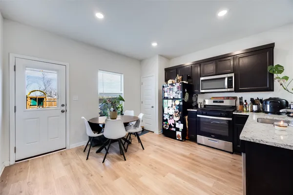 a kitchen with a refrigerator and a stove top oven