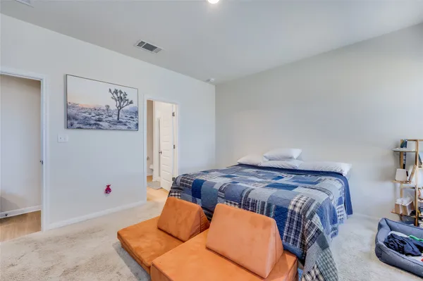 a bedroom with bed and wooden floor