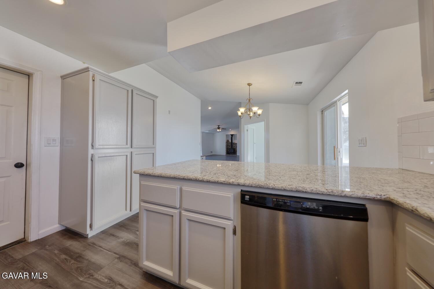 26801 Cabriolet Court Tehachapi, CA 93561 - Photo 16 of 60 a kitchen with stainless steel appliances granite countertop a sink and a refrigerator