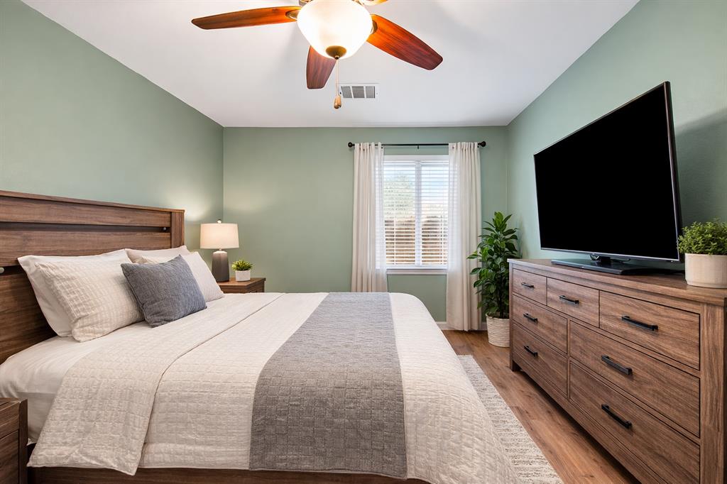 2304 Wilma Rudolph Road Austin, TX 78748 - Photo 13 of 18 Bedroom featuring light wood-style flooring and a ceiling fan