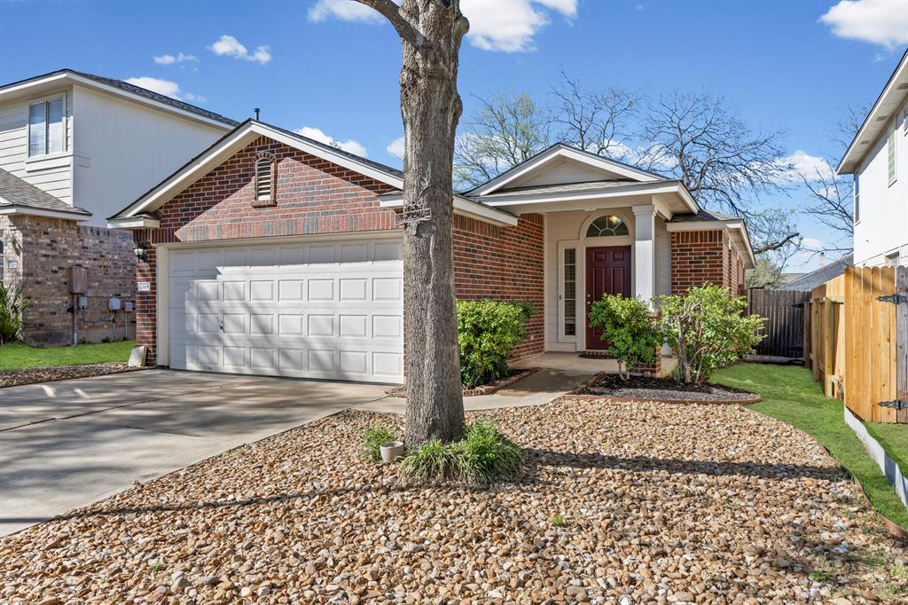 2304 Wilma Rudolph Road Austin, TX 78748 - Photo 2 of 18 View of front of house with brick siding, concrete driveway, and an attached garage