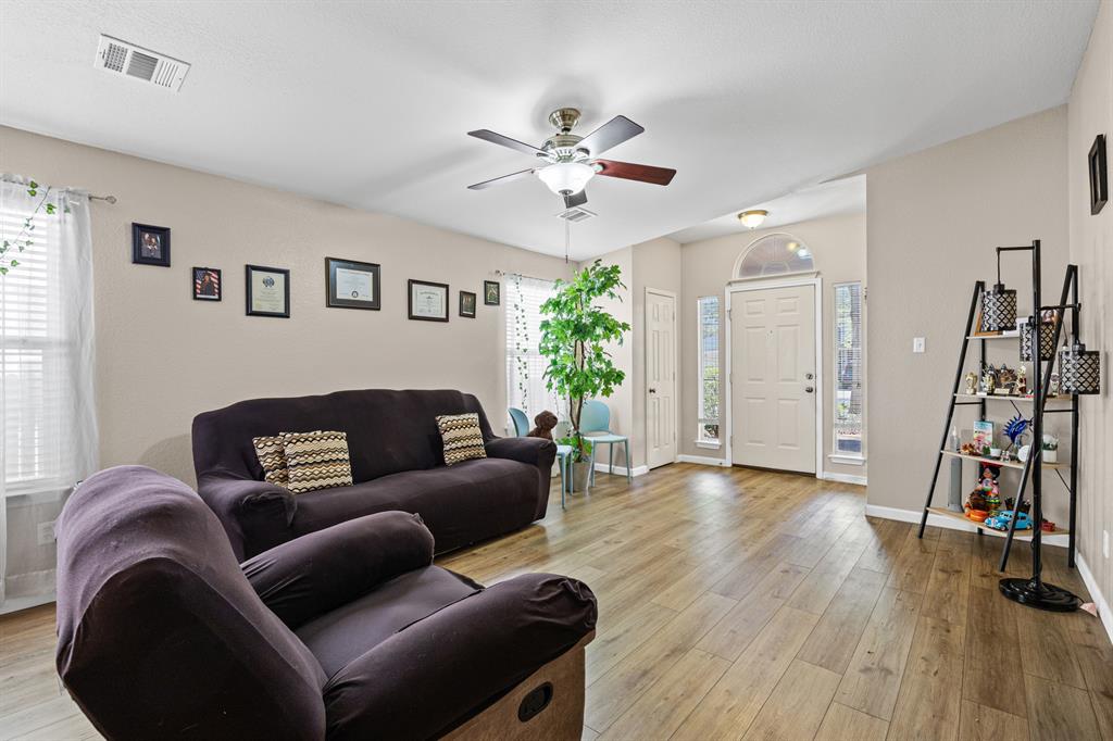 2304 Wilma Rudolph Road Austin, TX 78748 - Photo 4 of 18 Living room featuring a ceiling fan, light wood finished floors, and plenty of natural light