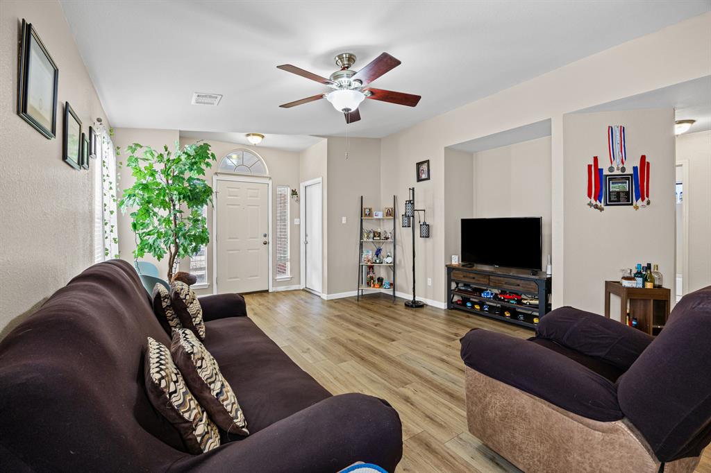 2304 Wilma Rudolph Road Austin, TX 78748 - Photo 5 of 18 Living room featuring light wood-style flooring and ceiling fan