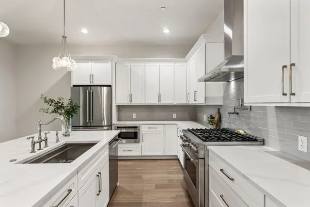 a kitchen with a sink stove and cabinets